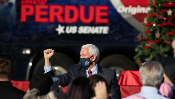 Vice President Mike Pence holds a fist up to the crowd during a rally in support of Sen. David Purdue (R-GA) and Sen. Kelly Loeffler (R-GA) on December 10, 2020 in Augusta, Georgia. The "Defend the Majority" rally comes ahead of a January 5th runoff election for Purdue who is facing Democratic candidate Jon Ossoff. Loeffler was unable to attend the event. Jessica McGowan/Getty Images/AFP Jessica McGowan / GETTY IMAGES NORTH AMERICA / Getty Images via AFP