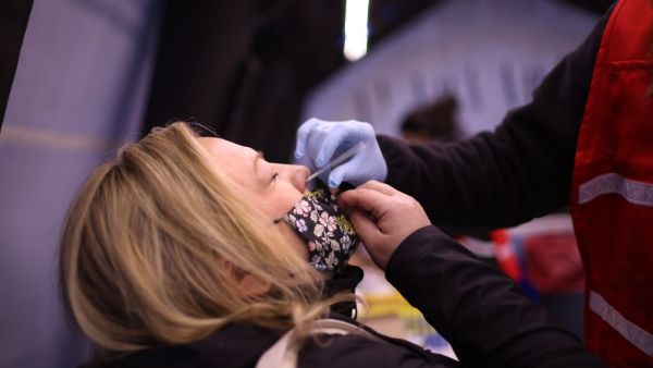 Kristin Nowak gets tested for Covid-19 at a mobile test site being run by Roseland Community Hospital on December 12, 2020 in Chicago, Illinois. The seven-day positivity rate in Illinois has been slowly receding but currently stands a 10.8%. Scott Olson/Getty Images/AFP