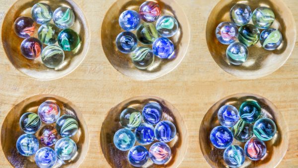Traditional Mancala boardgame with glass pieces on wooden table  (Shutterstock) Traditional Mancala boardgame with glass pieces on wooden table  (Shutterstock)