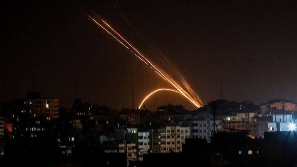 Illustrative: Rockets are fired from the Gaza Strip toward Israel, on November 13, 2019. (Anas Baba/AFP)