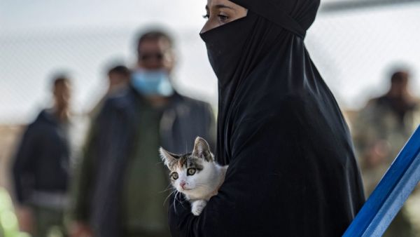 A Syrian woman, suspected of being related to Islamic State (IS) group fighters, carries a cat at the Kurdish-run al-Hol camp, before being released to return to their homes, in the al-Hasakeh governorate in northeastern Syria, on December 21, 2020. Delil SOULEIMAN / AFP