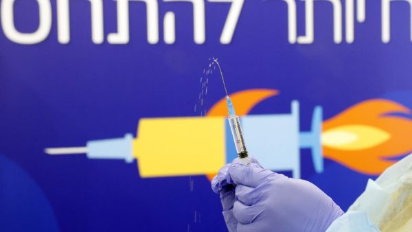 A healthcare worker prepares a dose of the Pfizer-BioNtech Covid-19 vaccine at a large vaccination centre open by the Tel Aviv-Yafo Municipality and Tel Aviv Sourasky Medical Center on December 31, 2020 in the Israeli coastal city. Israel began its third coronavirus lockdown, as Prime Minister Benjamin Netanyahu voiced optimism that a "world record" vaccination drive will restore a degree of normality within weeks. JACK GUEZ / AFP