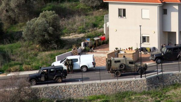 A picture taken from Lebanon's southern Tallet al-Hamamsah hill shows Israeli security forces on a road in the Israeli northern town of Metula, by the border blue line, on January 3, 2021, as Hezbollah supporters and members mark the first anniversary of the killing of slain Iraqi commander Abu Mahdi al-Muhandis, and Iranian Revolutionary Guards commander Qasem Soleimani. Ali DIA / AFP