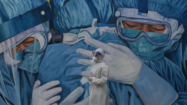 A medical personnel wearing a protective suit waits at the Covid-19 coronavirus drive-thru test centre outside the Ajwa Private Clinic in Shah Alam on the outskirts of Kuala Lumpur on January 12, 2021, as Malaysia's king declared a nationwide state of emergency to fight a coronavirus surge. Mohd RASFAN / AFP