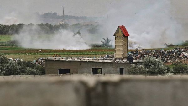 A picture taken on January 13, 2021 shows smoke rising at the scene of an Israeli attack on a Hamas position near the Palestinilan city of Khan Yunis in the southern Gaza Strip. The Israeli army fired artillery at Hamas targets in Gaza in response to what it described as gunfire from within Gaza on an "engineering vehicle" operating near the border.SAID KHATIB / AFP