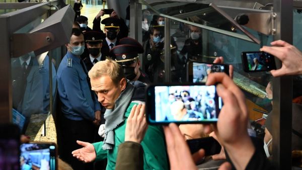Russian opposition leader Alexei Navalny is seen at the passport control point at Moscow's Sheremetyevo airport on January 17, 2021. Russian police detained Kremlin critic Alexei Navalny at a Moscow airport shortly after he landed on a flight from Berlin, an AFP journalist at the scene said. Kirill KUDRYAVTSEV / AFP Russian opposition leader Alexei Navalny is seen at the passport control point at Moscow's Sheremetyevo airport on January 17, 2021. Russian police detained Kremlin critic Alexei Navalny at a Moscow airport shortly after he landed on a flight from Berlin, an AFP journalist at the scene said. Kirill KUDRYAVTSEV / AFP