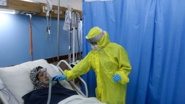 A medic cares for a COVID-19 patient at the Sheikh Ragheb Harb hospital supported by the Iranian Red Crescent, in Lebanon's southern city of Nabatiyeh, on January 18, 2021. Mahmoud ZAYYAT / AFP