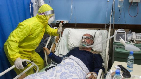 A medic cares for a COVID-19 patient at the Sheikh Ragheb Harb hospital supported by the Iranian Red Crescent, in Lebanon's southern city of Nabatiyeh, on January 18, 2021. Mahmoud ZAYYAT / AFP