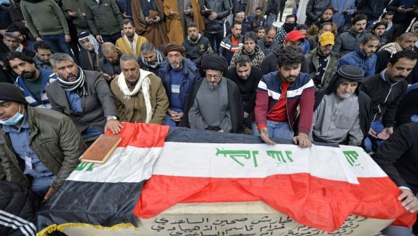 Iraqi mourners pray over the coffin of a victim who was killed in a twin suicide bombing in central Baghdad, during a funeral in the holy city of Najaf on January 21, 2021. A rare twin suicide bombing killed 32 people and wounded 110 at a crowded market in central Baghdad, Iraq's government said, the city's deadliest attack in three years. The first attacker drew a crowd at the bustling market in the capital's Tayaran Square by claiming to feel sick, then detonated his explosives belt, the interior ministry