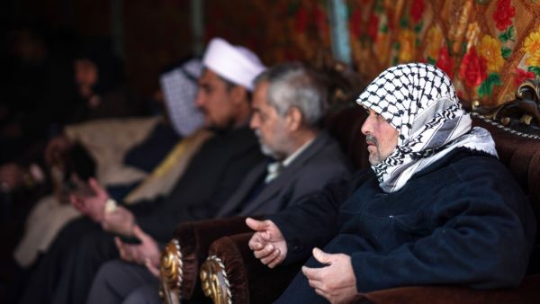 People console Louai al-Nuaimi (R), father of two Iraqi youngsters, Omar and Ali, killed in Baghdad's twin suicide attacks, during a condolences ceremony in the capital's Cairo neighbourhood, on January 22, 2021. Twin suicide blasts in Baghdad claimed by the Islamic State group have exposed gaps within Iraq's security forces, weakened by the COVID-19 pandemic, rival armed groups and political tensions. Ayman HENNA / AFP