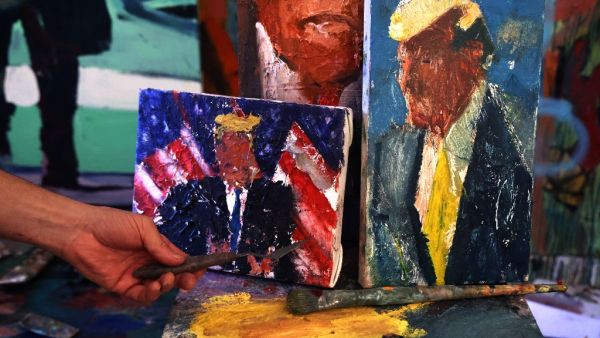 Israeli painter Iddo Markus displays some of his paintings of former US president Donald Trump, at his studio in the northern port city of Haifa, on January 22, 2021. Markus became fascinated by the "tragic figure" of Donald Trump, and the walls and floor of his studio are packed with some 120 portraits of the former US president. Emmanuel DUNAND / AFP