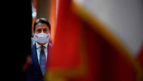 In this file photo taken on July 14, 2020, Italian Prime Minister Giuseppe Conte wearing a face mask attends a handover ceremony of the piece of art attributed to street artist Banksy, that was stolen at the Bataclan in Paris in 2019, and found in Italy, at the French embassy in Rome. Italian Prime Minister Giuseppe Conte will resign January 26, 2021, his office said on January 25, 2021, in what media reports said was a move to secure a mandate for a new government after weeks of turmoil. A statement from C