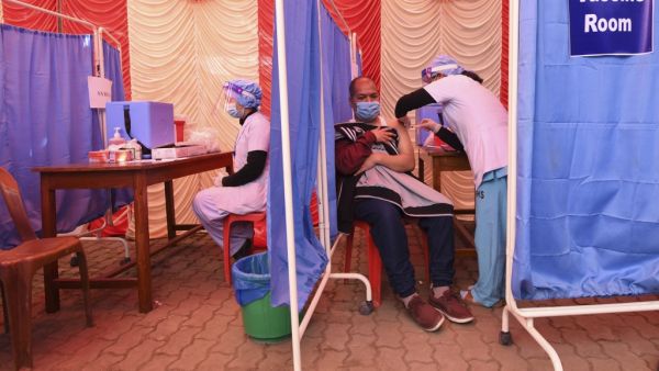 A health worker receives a dose of Covishield, AstraZeneca-Oxford's COVID-19 coronavirus vaccine made by local partner Serum Institute of India, at Patan Hospital near Kathmandu on January 27, 2021. PRAKASH MATHEMA / AFP A health worker receives a dose of Covishield, AstraZeneca-Oxford's COVID-19 coronavirus vaccine made by local partner Serum Institute of India, at Patan Hospital near Kathmandu on January 27, 2021. PRAKASH MATHEMA / AFP