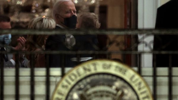 U.S. President Joe Biden holds his grandson Beau Biden before watching a fireworks show on the National Mall from the Truman Balcony at the White House January 20, 2021 in Washington, DC. Biden became the 46th president of the United States earlier today during the ceremony at the U.S. Capitol. Chip Somodevilla/Getty Images/AFP