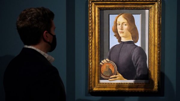 A preview of Sandro Botticelli's "Young Man Holding a Roundel" at Sotheby's on January 22, 2021 in New York City. Sotheby’s will offer the painting as part of the annual Masters Week sales series. The work is estimated to sell for in excess of $80 million, which will establish it in art market history as one of the most significant portraits to ever appear at auction. Cindy Ord/Getty Images/AFP Cindy Ord / GETTY IMAGES NORTH AMERICA / Getty Images via AFP