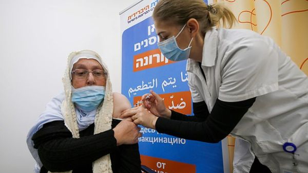 Pictured: A woman gets vaccinated against the COVID-19 coronavirus in the Israeli-annexed Golan Heights. (AFP)