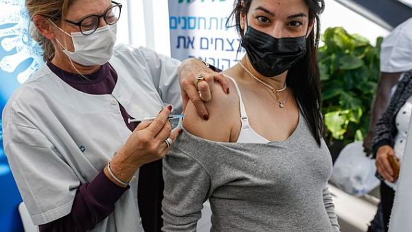 Pictured: A health worker administers a dose of the Pfizer-BioNTech COVID-19 at Clalit Health Services, in Tel Aviv, January 23. (AFP)