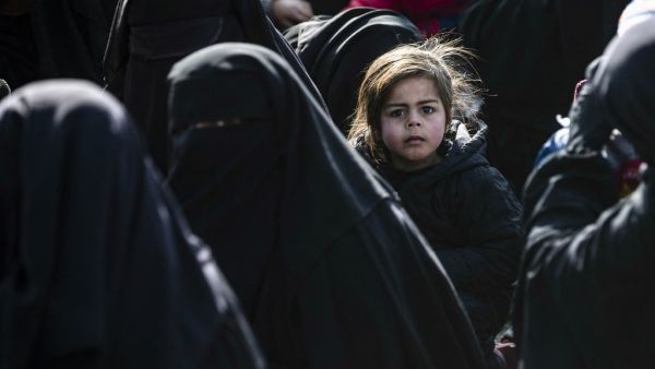Women lead children ahead of departure during the release of another group of Syrian families from the Kurdish-run al-Hol camp which holds suspected relatives of Islamic State (IS) group fighters, in Hasakeh governorate in northeastern Syria, on January 28, 2021. Delil SOULEIMAN / AFP