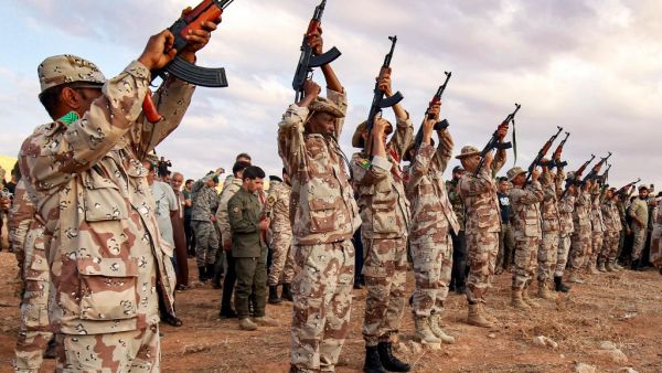 In this file photo taken on November 01, 2020 fighters fire salutatory rounds in the air during the funeral of General Wanis Bukhamada, commander of the "Saiqa" (Special Forces) of the self-proclaimed Libyan National Army (LNA) loyal to strongman Khalifa Haftar, in the eastern city of Benghazi. The United States on January 28, 2021 called for the immediate withdrawal of Russian and Turkish forces from Libya, after a deadline for them to leave was ignored. Abdullah DOMA / AFP