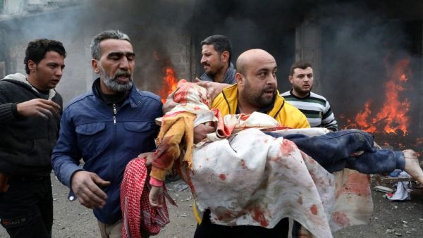 Civilians carry a young victim at the scene of an explosion in the town of Azaz in the rebel-controlled northern countryside of Syria's Aleppo province,on January 31, 2021. A car bomb killed at least four people, including three civilians, in the Turkish-held northern town of Azaz in war-torn Syria today, a war monitor said. Nayef Al-ABOUD / AFP