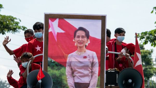 This file photo taken on October 25, 2020 shows supporters of the National League for Democracy (NLD) party taking part in an election campaign event with a portrait of Myanmar State Counsellor Aung San Suu Kyi in Yangon. Myanmar's ousted National League for Democracy party called for the release of Aung San Suu Kyi and other detained leaders on February 2, 2021, describing the coup a day earlier as a "stain" on the military's history. Sai Aung Main / AFP