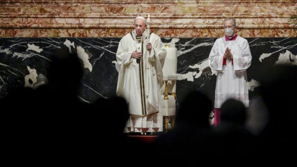 Pope Francis (C), assisted by Master of Pontifical Liturgical Ceremonies, Italian priest Guido Marini (R), celebrates mass on the occasion of the celebration of the World Day of Consecrated Life at St. Peter's Basilica in the Vatican on February 2, 2021. Andrew Medichini / POOL / AFP