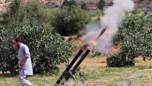 In this file photo taken on April 19, 2020, a fighter with Libya's UN-recognised Government of National Accord (GNA) fires rockets from a position near the town of Garabulli toward the city of Tarhuna, southwest of the capital Tripoli, held by the forces of the Libyan strongman Khalifa Haftar. Mahmud TURKIA / AFP