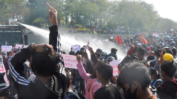 A police vehicle fires water cannon in an attempt to disperse protesters during a demonstration against the military coup in Naypyidaw on February 8, 2021 STR / AFP