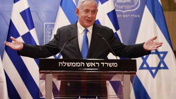 Israeli Prime Minister Benjamin Netanyahu delivers a statement next to the Greek Prime Minister Kyriakos Mitsotakis (unseen) after their meeting in the Prime Minister's office in Jerusalem on February 8, 2021. menahem kahana / POOL / AFP