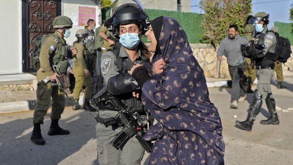 A woman reacts as Israeli security forces demolish the house of Palestinian Mohammed Cabha who has confessed to the murder of French-Israeli settler Esther Horgen, in the West Bank village of Tura al-Gharbiya near Jenin, on February 10, 2021. JAAFAR ASHTIYEH / AFP
