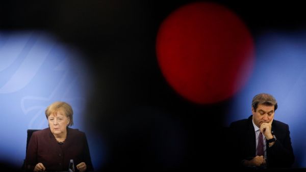 German Chancellor Angela Merkel (L) and Bavarian State Premier Markus Soeder (R) hold a news conference following talks via video conference with Germany's state premiers on the extension of the current lockdown due to the coronavirus COVID-19 pandemic, at the Chancellery in Berlin, on February 10, 2021. Markus SCHREIBER / POOL / AFP