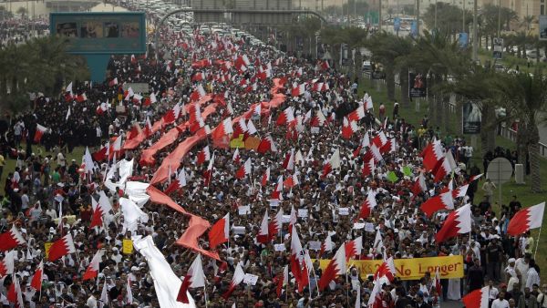 In this file photo taken on February 25, 2011 Bahraini Shiite anti-government protesters chant slogans against the regime during a rally in remembrance of the seven people who were killed in police crackdowns as they march towards Pearl Square in Manama. With a popular, reform-minded crown prince newly installed as prime minister, and a decade passed since the Arab Spring, Bahrain should be well placed to cast off the painful legacy of its uprising. The Pearl monument in downtown Manama -- the centre of the