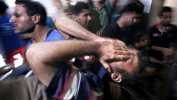In this file photo taken on July 16, 2014, a Palestinian relative of the four boys killed in Israeli bombardment while playing on the beach, all from the extended Bakr family, reacts at the morgue of the al-Shifa hospital in Gaza City. The International Criminal Court's ruling that it has jurisdiction over the situation in the Palestinian territories opens the way to it investigating alleged war crimes committed in the 2014 Israeli-Palestinian conflict in Gaza. In the summer of 2014, Israel launched what it