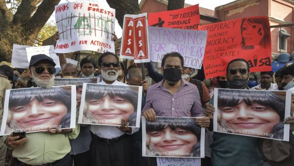 Activists belonging to various human rights organisations hold placards as they stage a demonstration against the arrest of the activist Disha Ravi by Delhi police for her alleged involvement in the instigation of violence during the farmers protest on India's Republic Day, in Bangalore on February 15, 2021. Manjunath Kiran / AFP