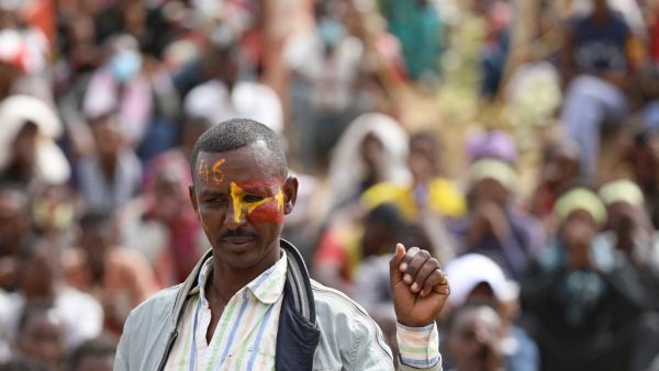 An Ethiopian refugee attends a gathering to celebrate the 46th anniversary of the Tigray People's Liberation Front at Um Raquba refugee camp in Gedaref, eastern Sudan, on February 19, 2021. In remote eastern Sudan, refugee activists are keeping the flame burning for the former rebels who dominated Ethiopian politics before being ousted from their regional stronghold of Tigray last year. Hussein Ery / AFP