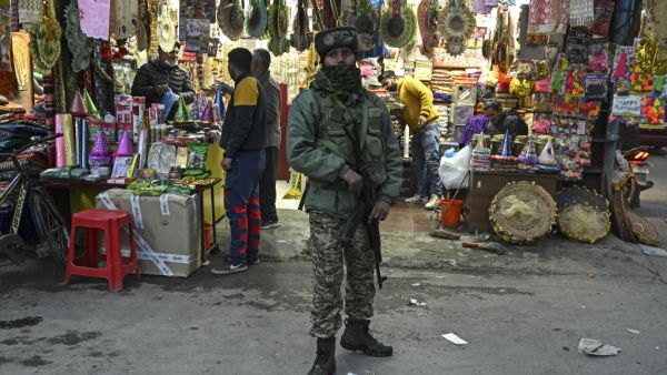 Indian paramilitary trooper stands guard along a street following an attack which killed two policemen last week, in Srinagar on February 24, 2021. TAUSEEF MUSTAFA / AFP