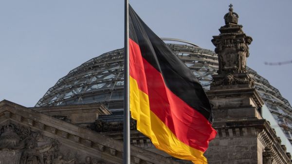 The German flag flys outside the Reichstag, the building which houses the Bundestag (the German lower house of parliament) on February 24, 2021 in Berlin. David GANNON / AFP