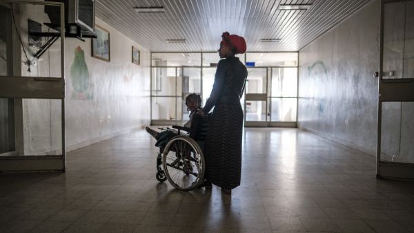 Arsema Berha, 9-years-old, is pushed by her mother as she sits in a wheelchair at the Ayder Referral Hospital in the Tigray capital Mekele on February 25, 2021, after being injured during fighting between the Tigray People's Liberation Front (TPLF) which fell after Ethiopian Prime Minister deployed troops and warplanes to oust the TPLF late last year. (AFP/File)