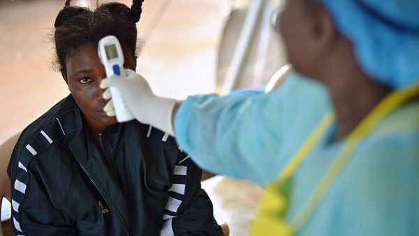 A girl suspected of being infected with the Ebola virus having her temperature checked at the government hospital in Kenema, Sierra Leone, in August 2014. (AFP/File)