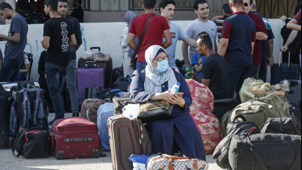 Hundreds of Gazans assembled before dawn in the waiting area. [Said Khatib/AFP]