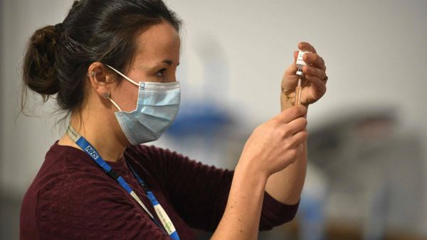 A doctor prepares to administer the Oxford-AstraZeneca COVID-19 vaccine at a temporary vaccination center in the Keepmoat Stadium in Doncaster, England. (AFP File Photo) 