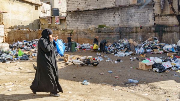 palestianans searching food in the dumb in Sabra and shatila refugee camp in beirut Lebanon 3 February 2018. (Shutterstock)