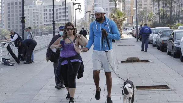 A couple and their dog on the Beirut promenade 