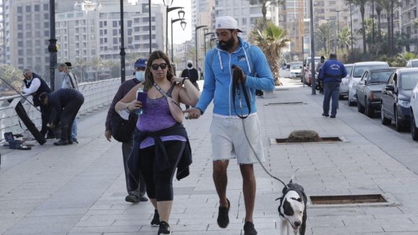 A couple and their dog on the Beirut promenade 