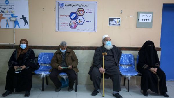 People wait to receive the Sputnik V COVID-19 vaccine at the United Nations Relief and Works Agency for Palestine Refugees (UNRWA) clininc in the Rafah camp for Palestinian refugees in the southern Gaza Strip