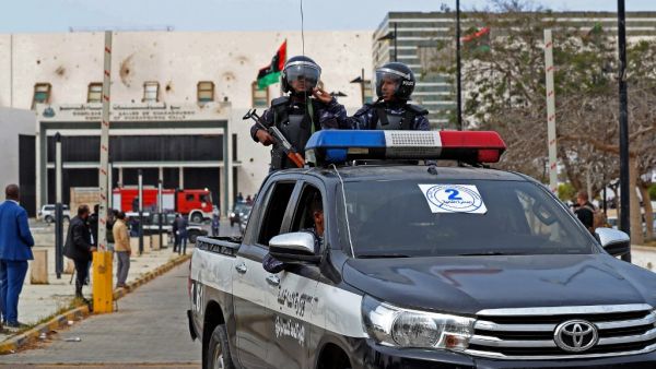 Libyan security forces keep watch outside the Ouagadougou Conference 