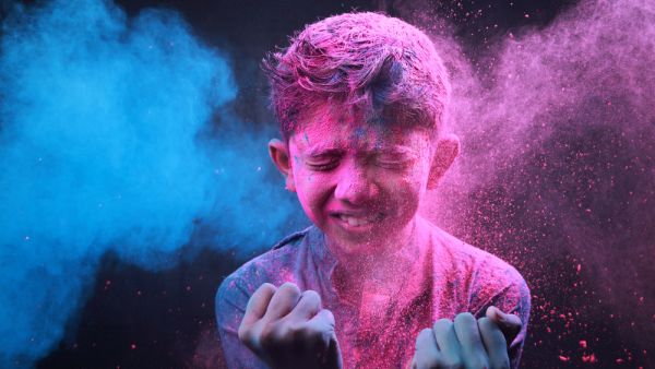 Little boy plays with colors.Concept for Indian festival Holi.