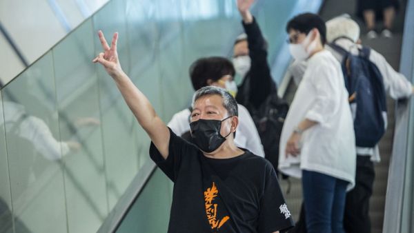 Pro-democracy activist Lee Cheuk-yan (C) gestures outside West Kowloon Court in Hong Kong 