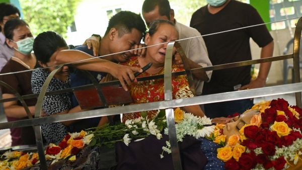 Relatives cry at the body of Su Su Kyi