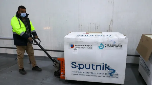 A worker handles the first batch of the Russian Sputnik V vaccine 